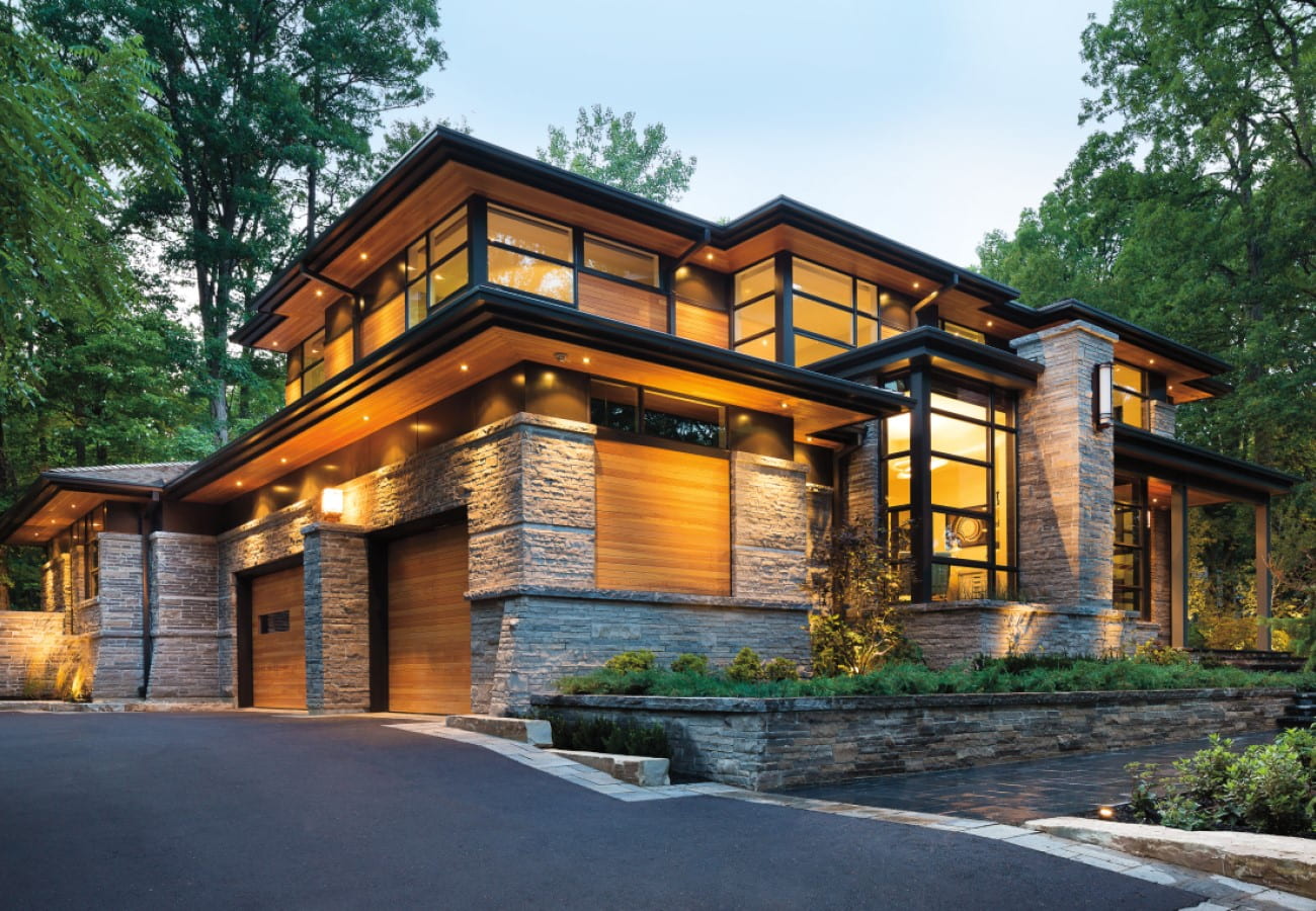 Modern home with black-frame windows and wood-and-stone exterior