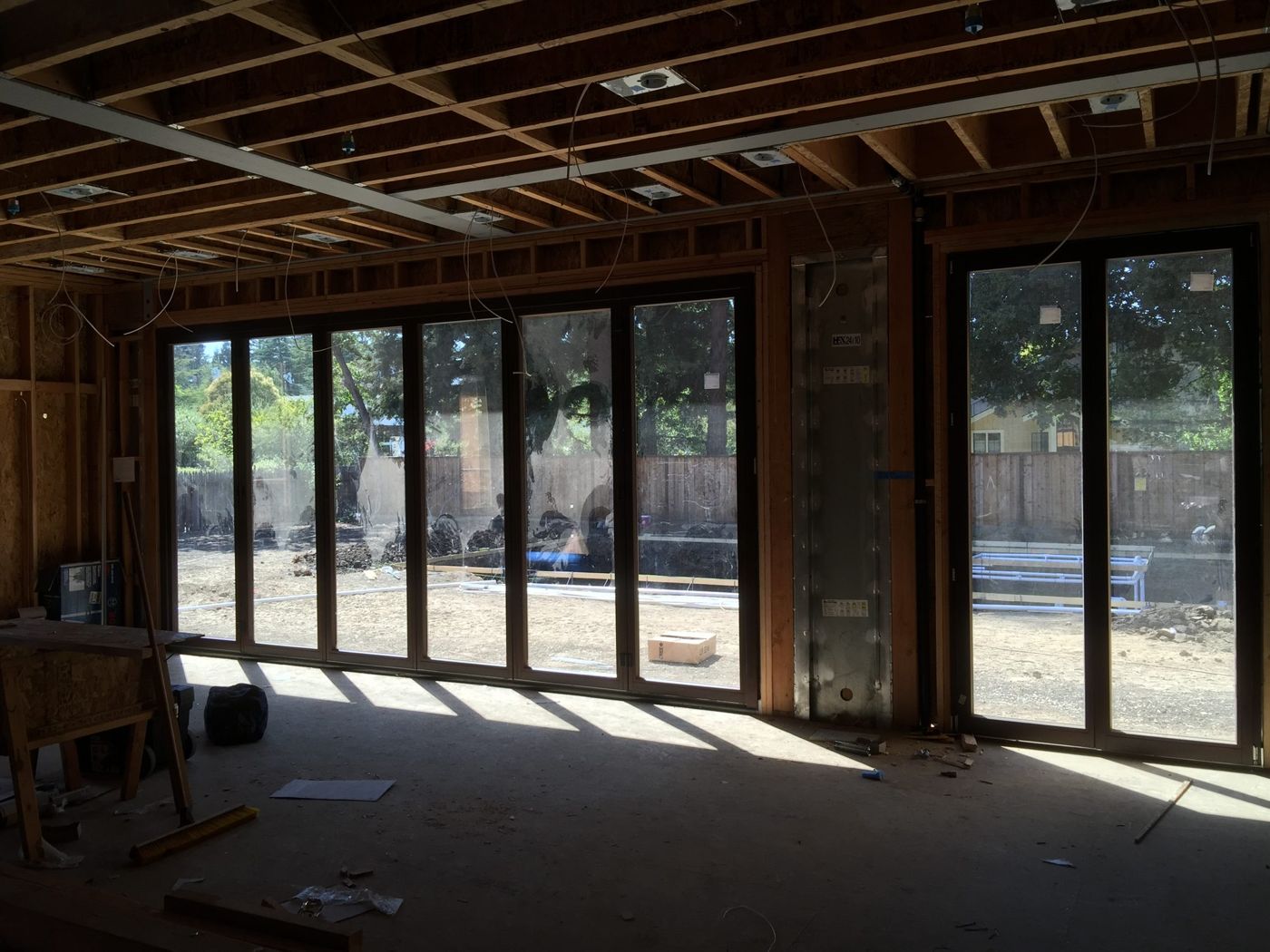 Glass garage-style door system installation in Costa Mesa, CA